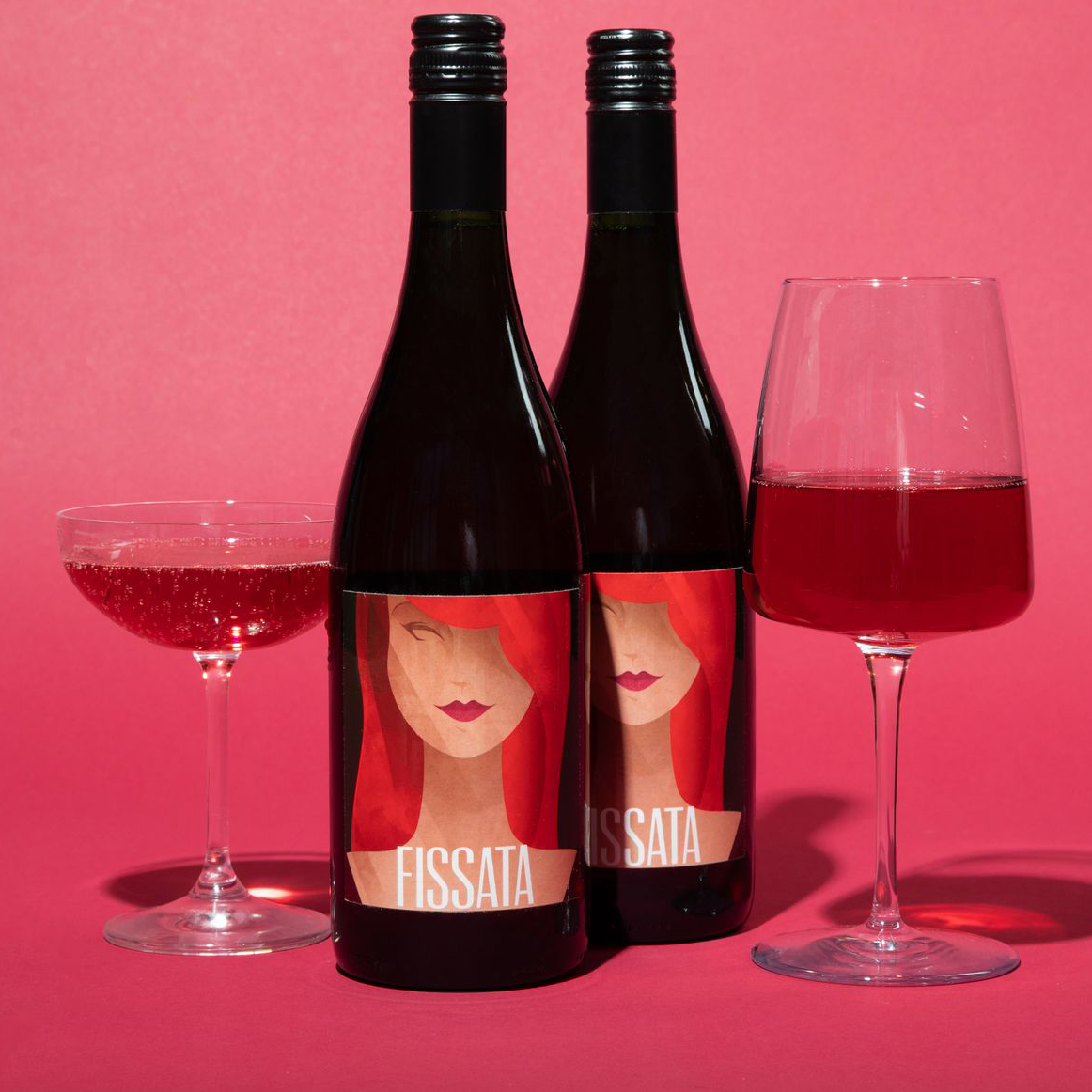 Two bottles of Fissata Sweet Red Wine with wine glasses